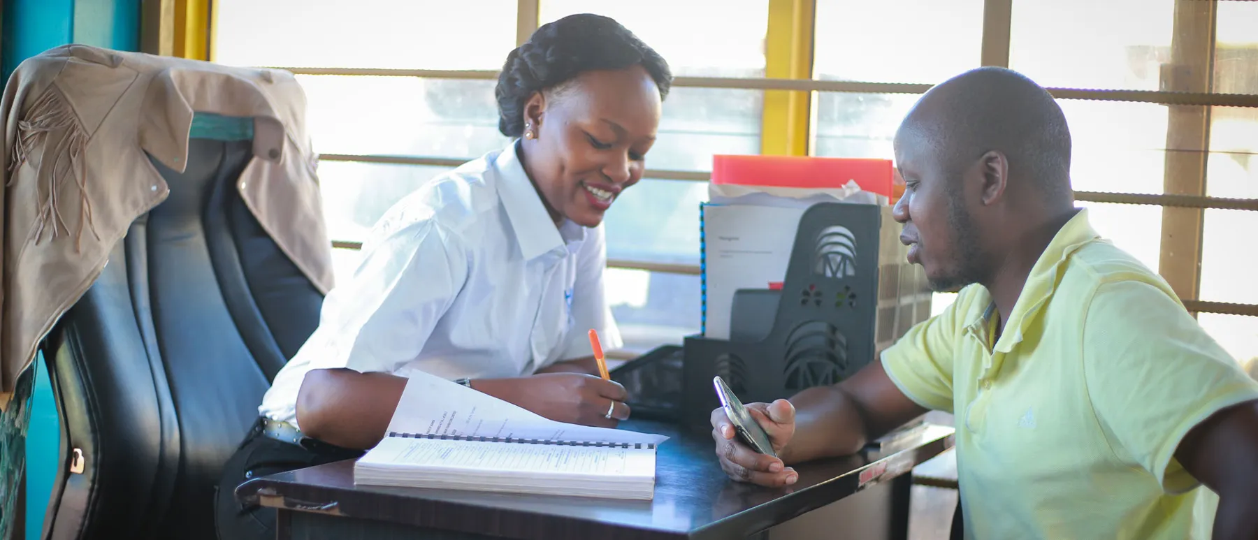 Two HICO team members working at a desk